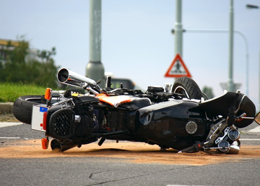 Overturned motorcycle on its side after a severe accident on the road.