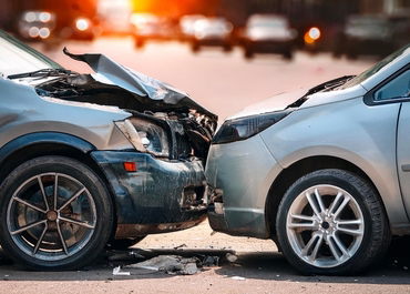 Head-on collision between two cars at sunset, 5 Common Types Of Car Accidents.