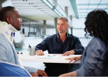 Client in a neck brace meets with a personal injury attorney.