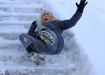 Woman falling backward onto snowy stairs after slipping on ice, icy Slip & Fall Plaintiff Awarded $2.25 Million For Back Injury.