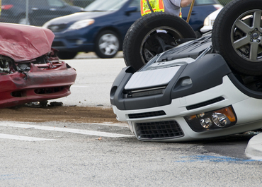 Vehicle overturned and another severely damaged after an intersection collision.