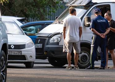 Investigators and police examine a truck and other vehicles after an accident.