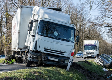 Truck swerving off-road toward a ditch, representing a negligent trucking company, Investigating Trucking Company Negligence In Accident Cases.