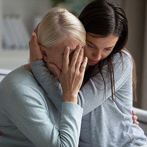 Sad girl sitting with elderly woman after loss – Edward Blinder, New Jersey wrongful death attorney