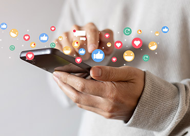 Person using smartphone with social media icons; how posts impact NJ personal injury claims.